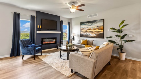 Spacious living room with two large windows and overhead fan