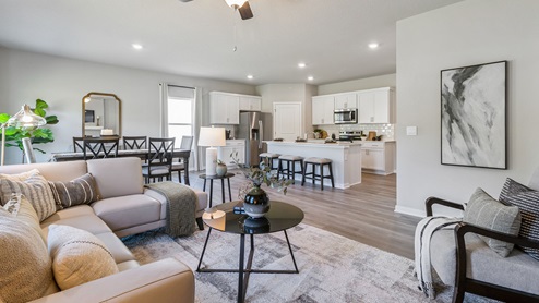 Living room with chairs and coffee table with view of kitchen