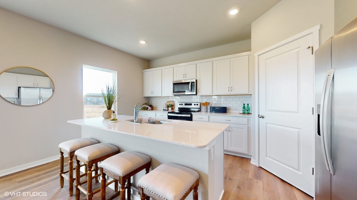 Kitchen with white cabinets with island