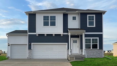 Holland exterior with blue and white siding, front porch, and 3 car garage