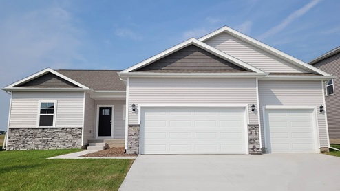 Reagan exterior with grey siding, 3 car garage and stone
