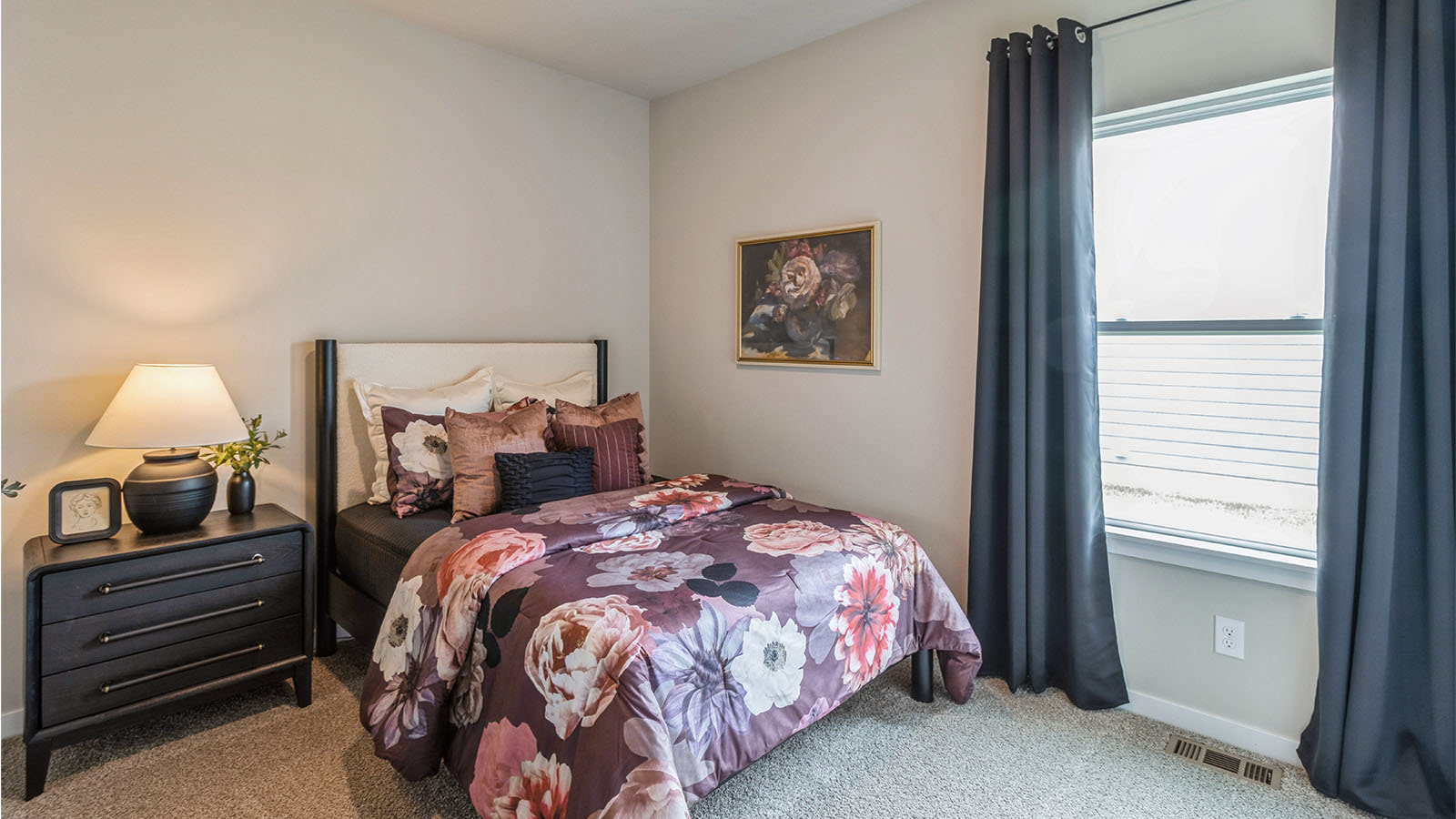 third bedroom with queen bed and overhead lighting and small window