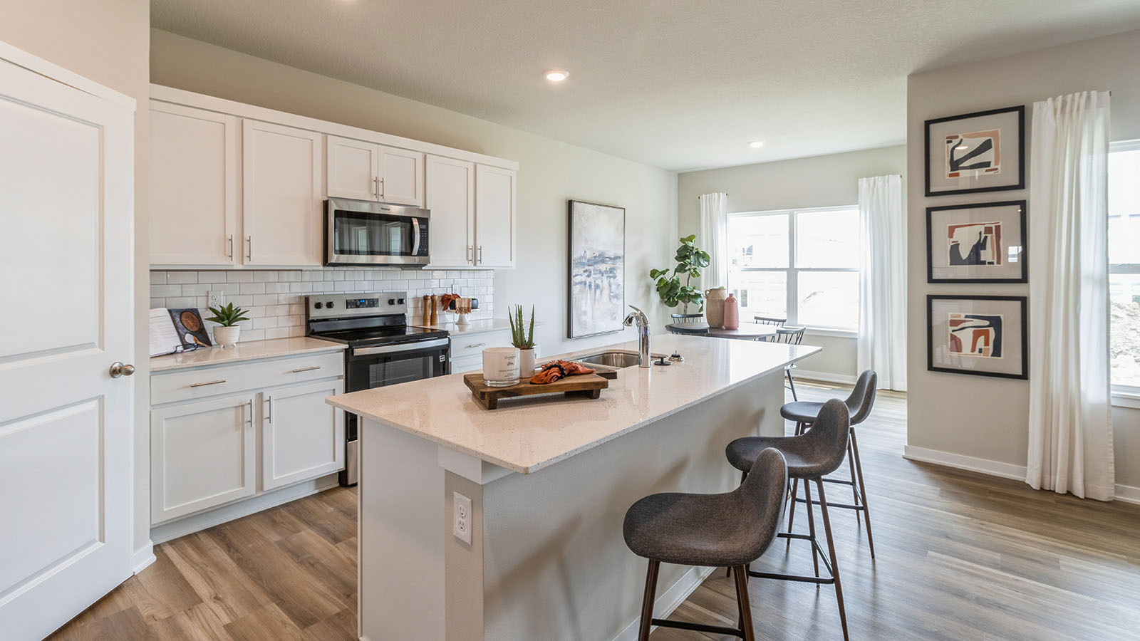 large kitchen with stainless-steel appliances and quartz countertops