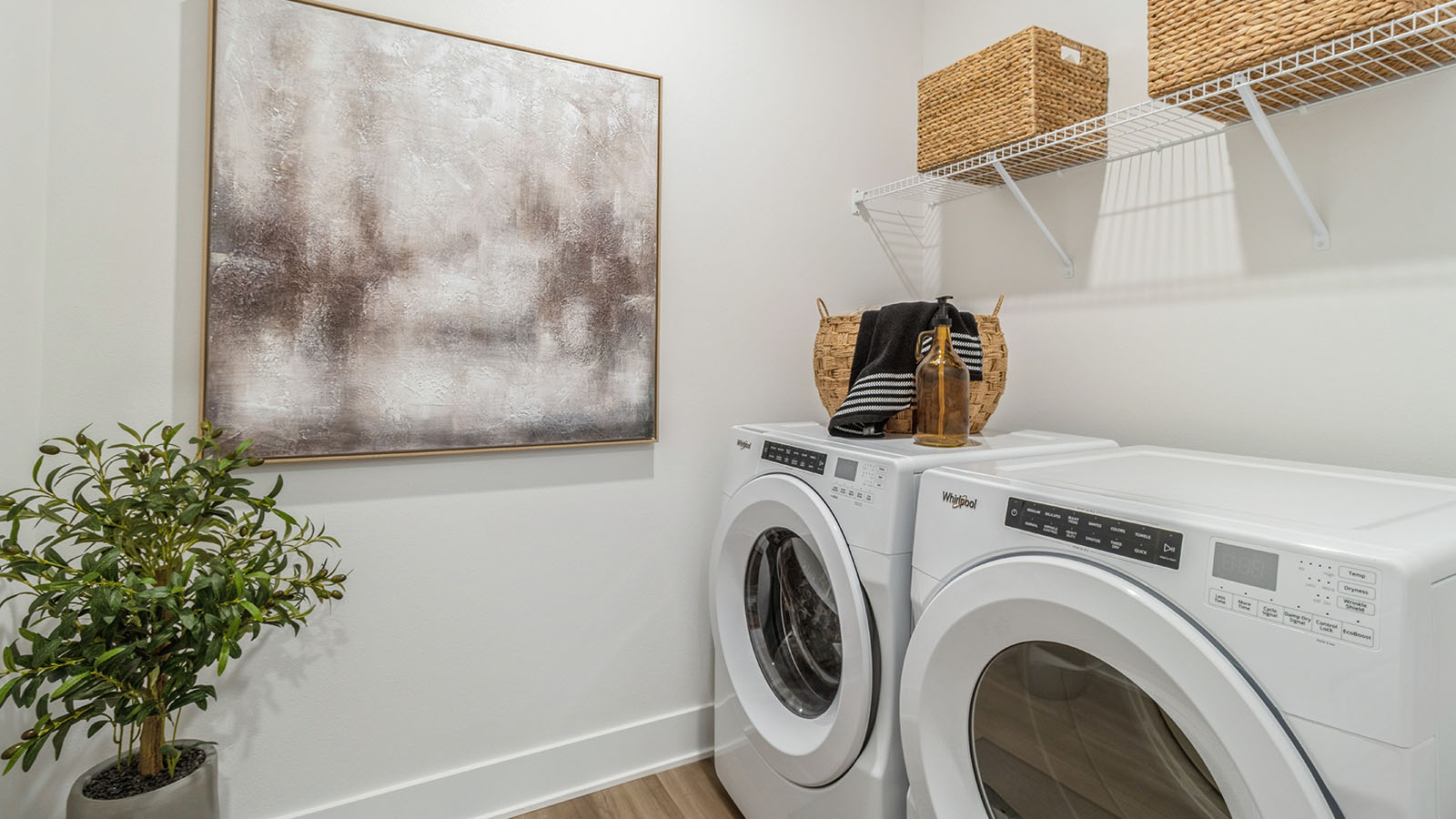 Laundry room with washer and dryer and white wire shelving overhead
