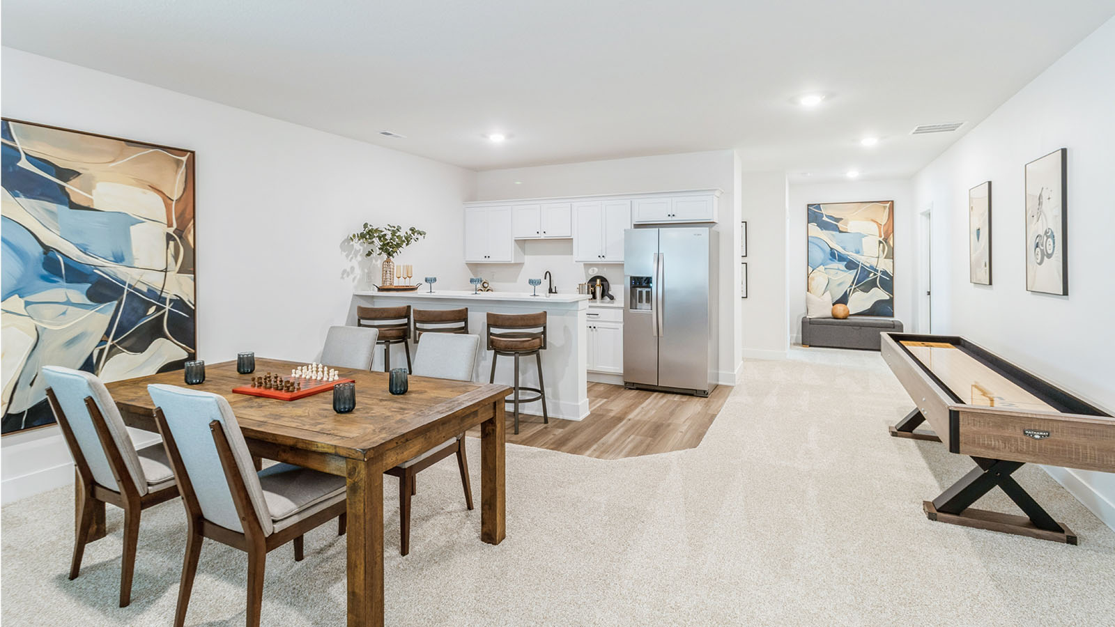 Finished basement with wood dining table and wet bar