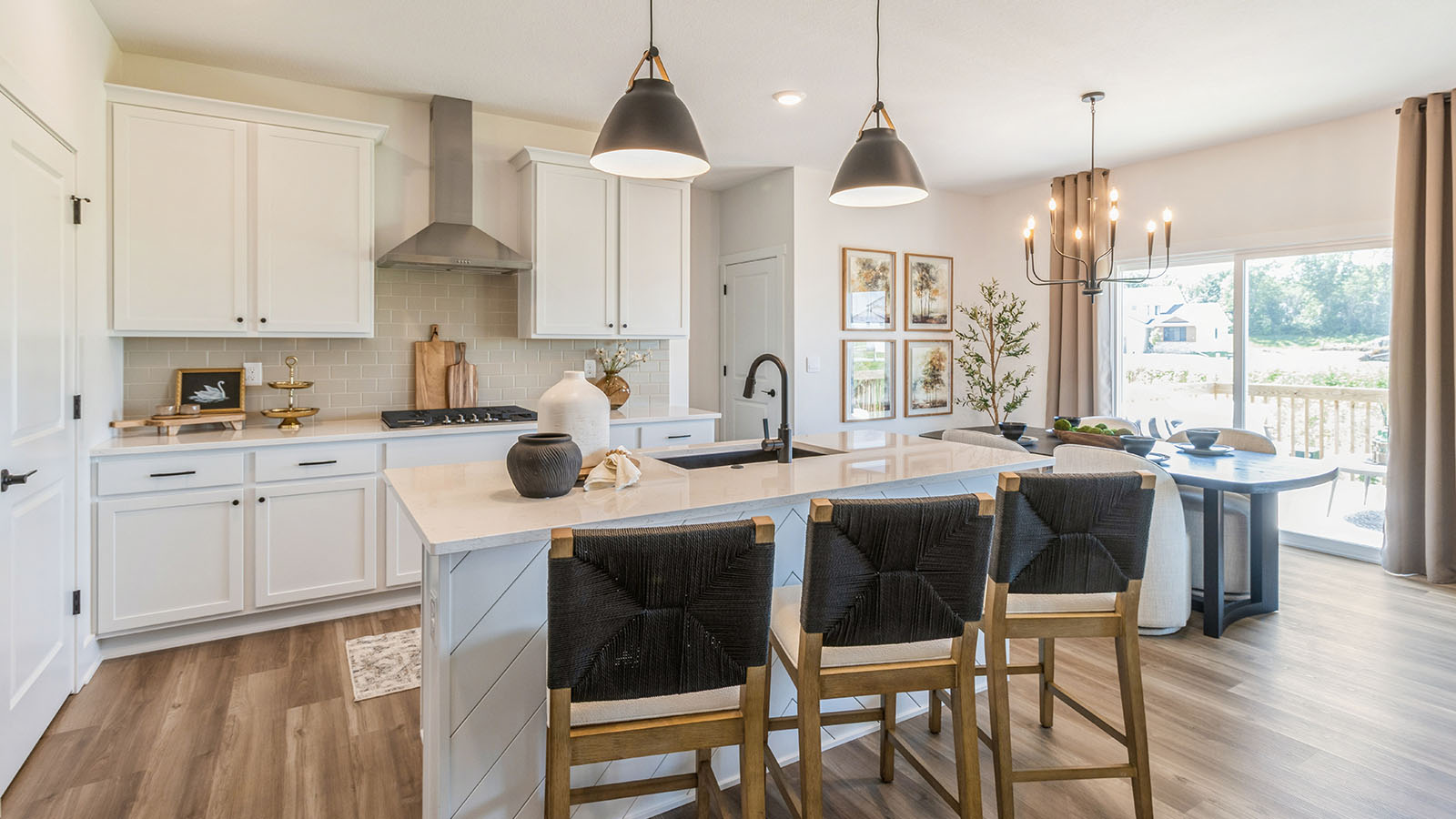 White kitchen with quartz countertops and island with pendant light fixtures