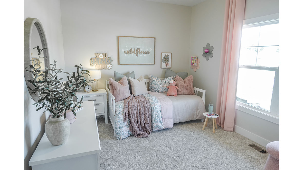 bedroom with beige carpet, white walls and a window