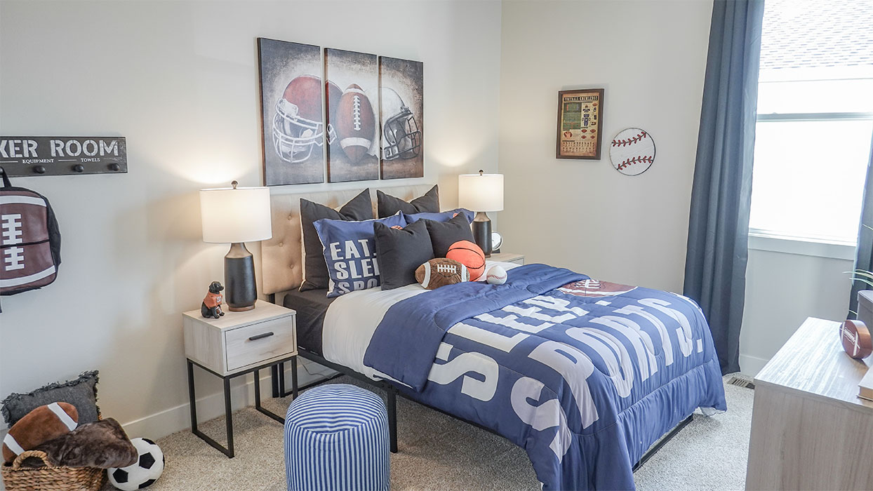 bedroom with beige carpet, white walls and a window