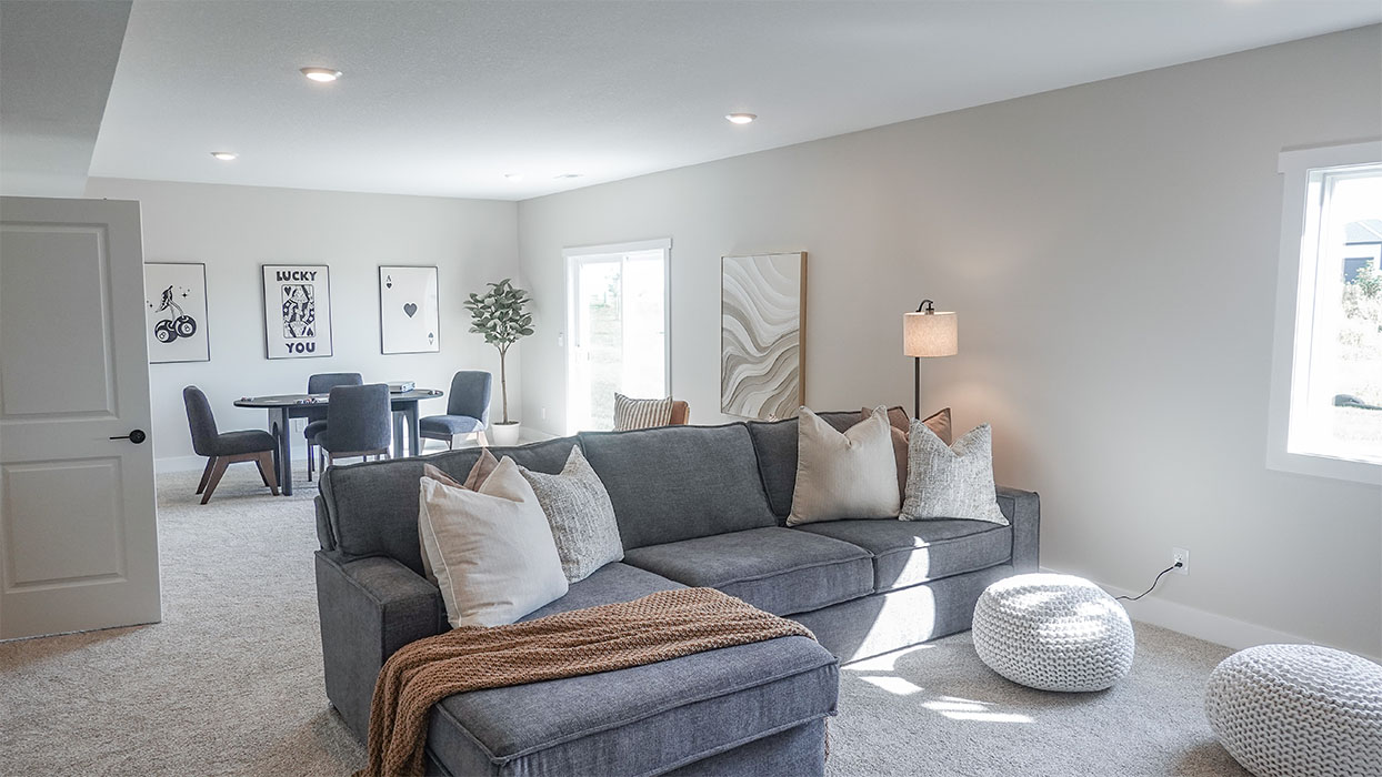 spacious flex room with a couch and game table