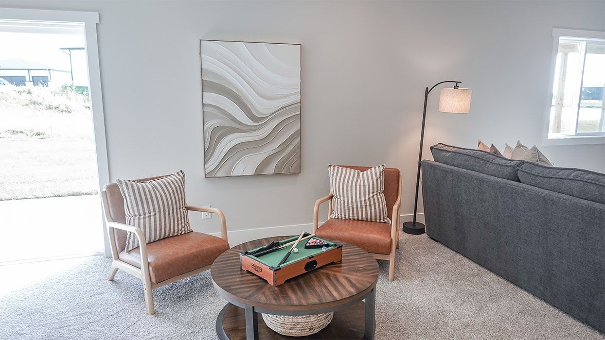 spacious flex room with a couch and game table