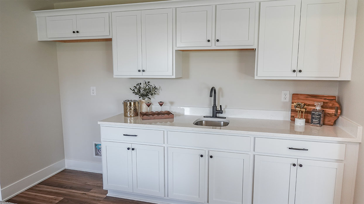 kitchen with white cabinetry, large island, and stainless steel appliances