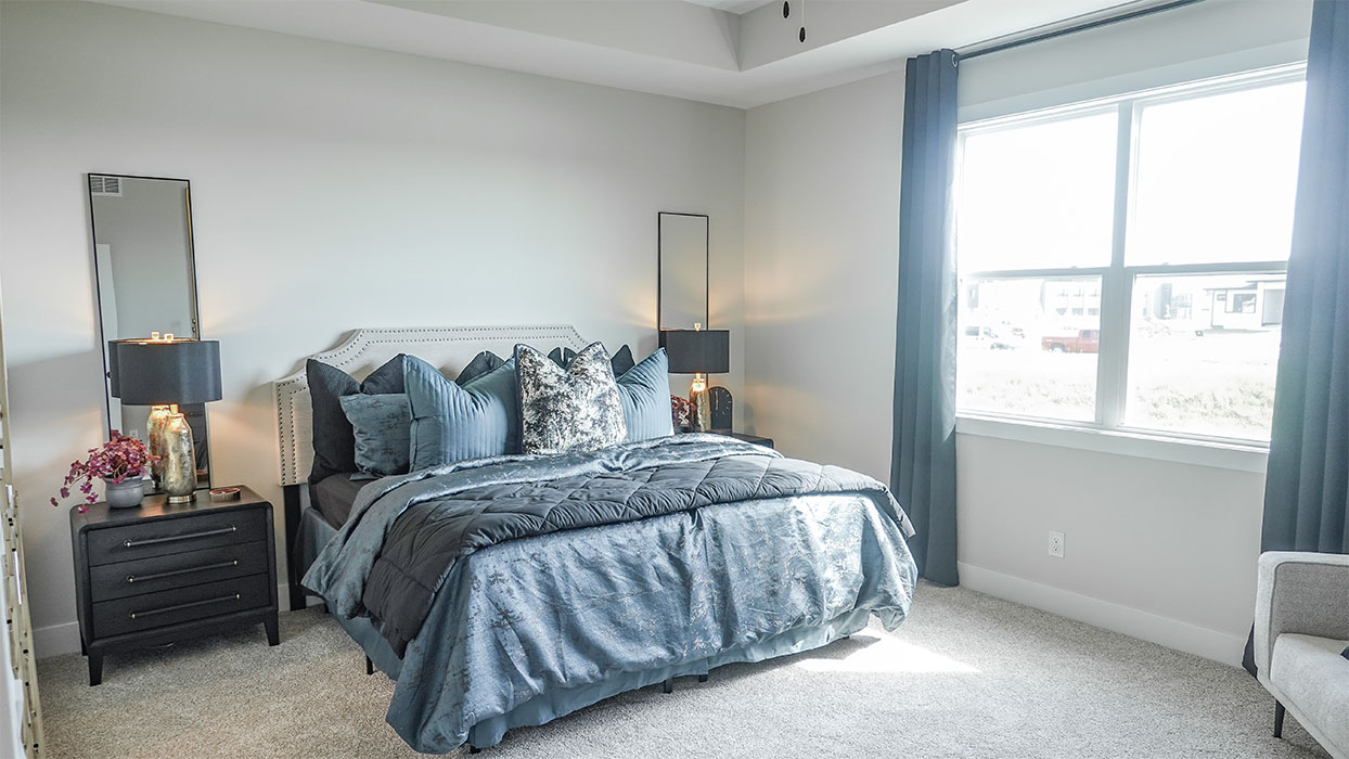 bedroom with beige carpet, white walls and a window