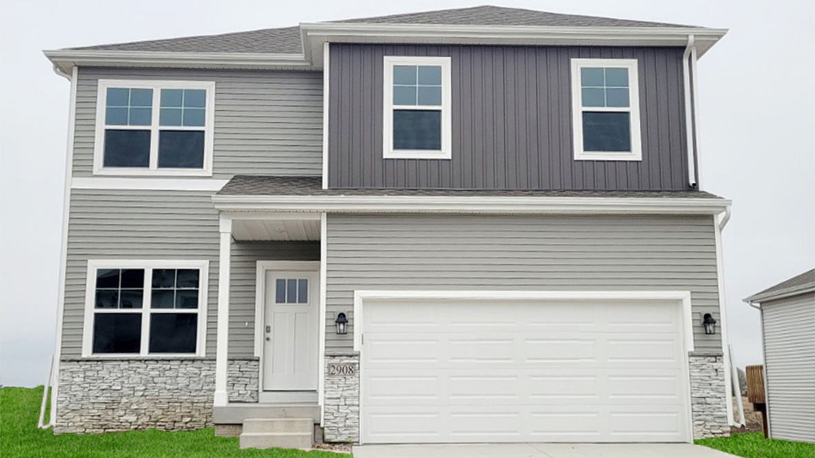 front exterior of a two story home with a two car garage