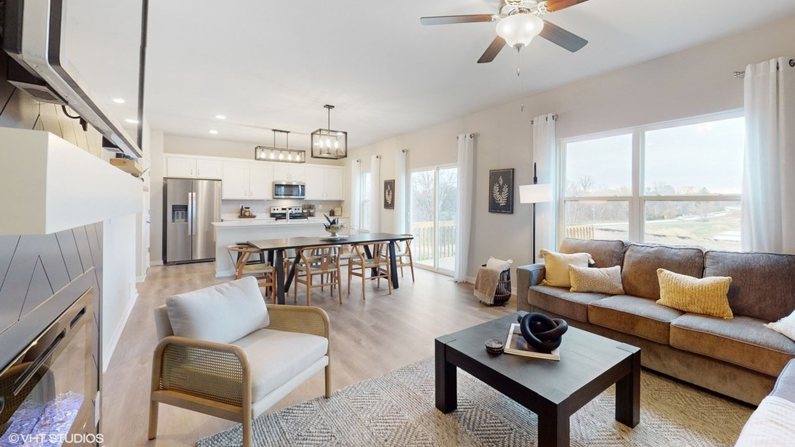 Living room with modern fixtures, electric fireplace and convenient central traffic flow throughout Forevergreen Heights