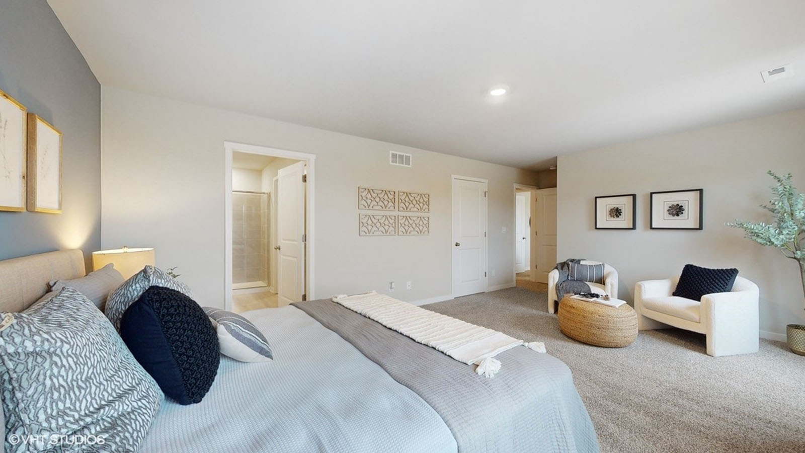 Primary suite by D.R. Horton includes corner window views, details like walk-through access to en suite bathroom, walk-in closet