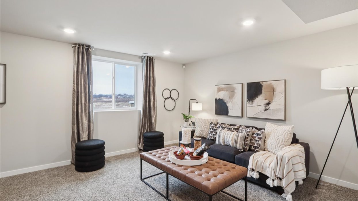 Finished basement living area with comfortable seating space and flexible room for entertaining or relaxing.