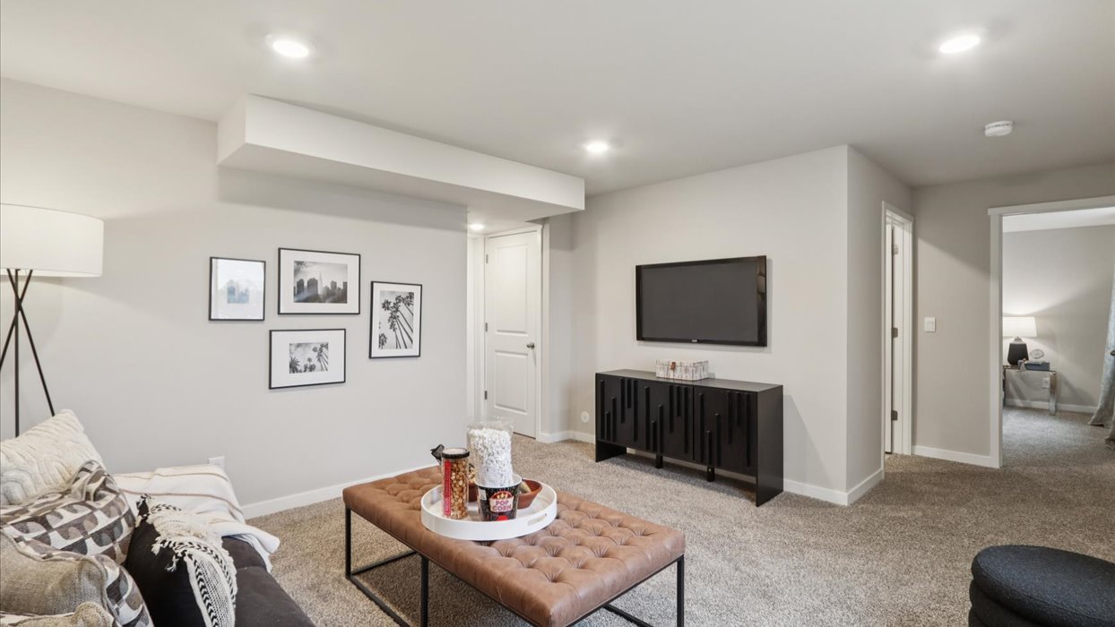 Finished basement living area with comfortable seating space and flexible room for entertaining or relaxing.