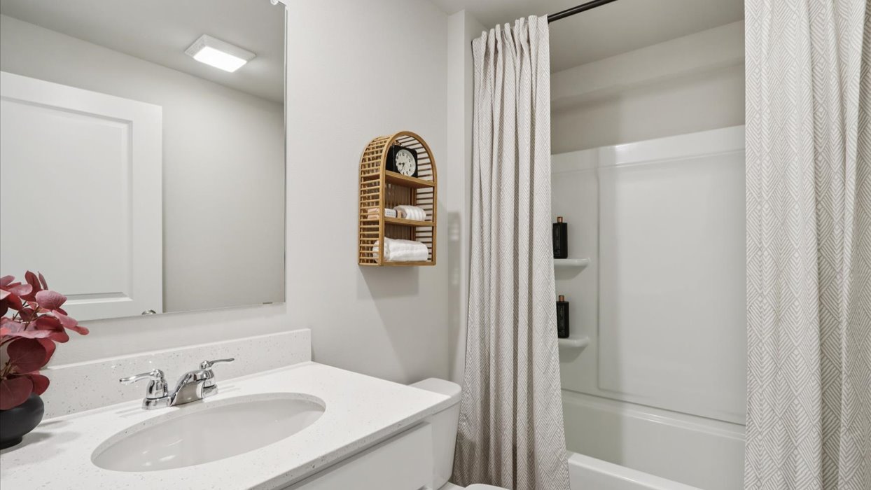 Bathroom with tub and shower combo, quartz countertops, and white vanity