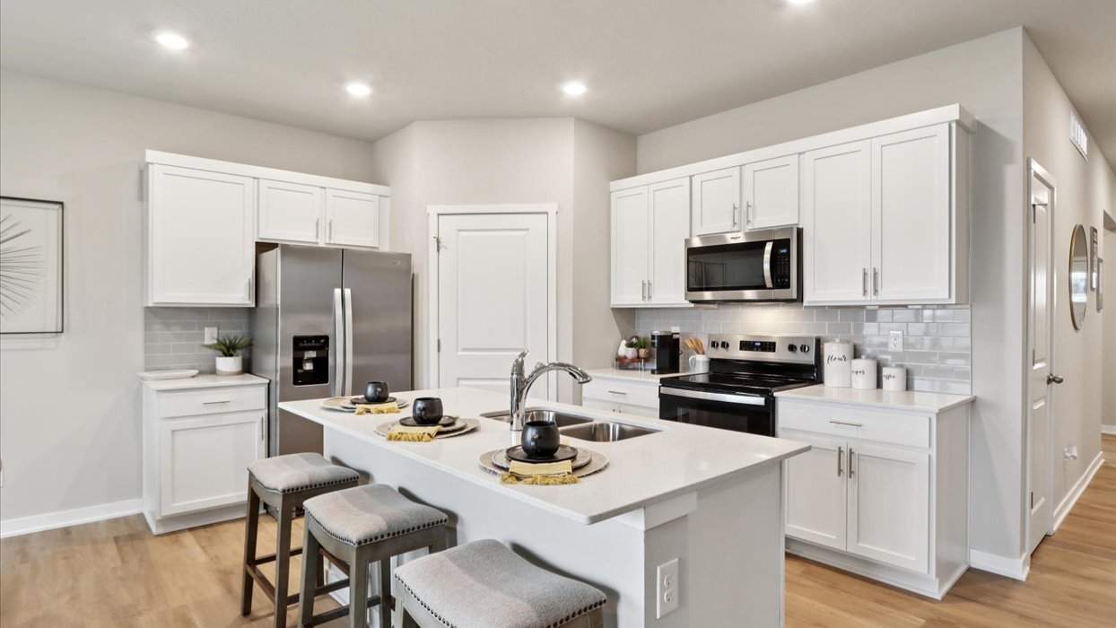 modern white kitchen with island and quartz countertops