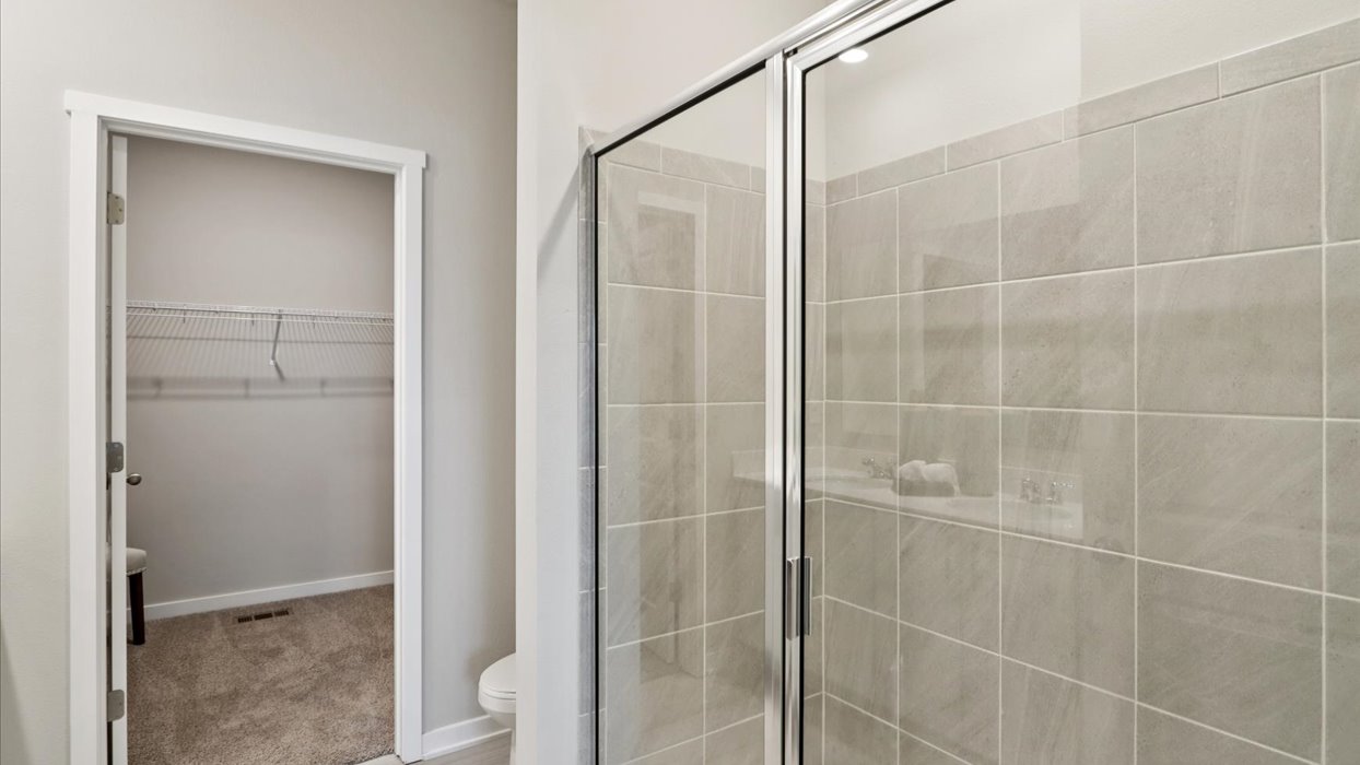 Spacious bathroom with white cabinetry and double sinks
