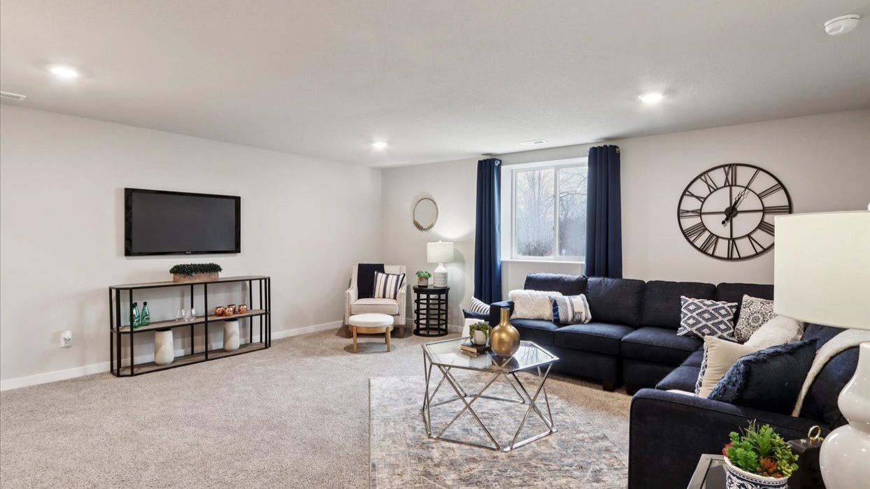 Finished basement living area with comfortable seating space and flexible room for entertaining or relaxing.