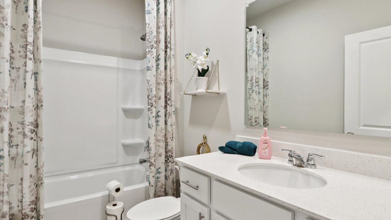 Stylish full bathroom with bright lighting and functional design.