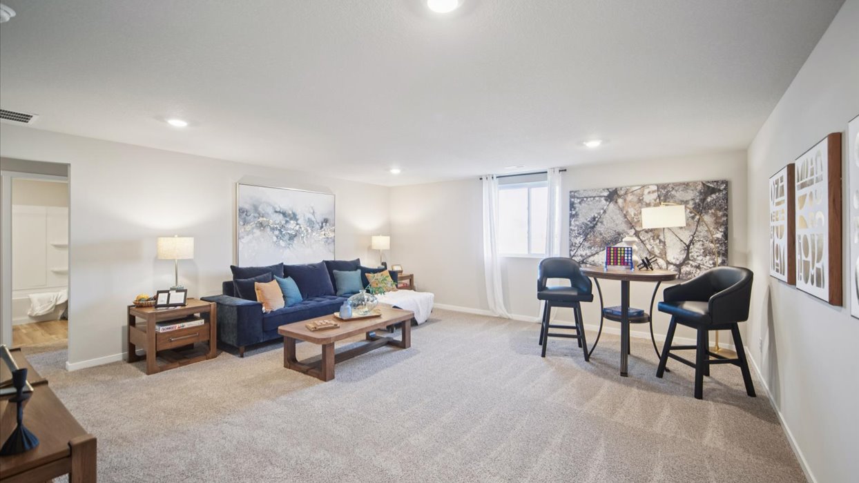 Finished basement living area with comfortable seating space and flexible room for entertaining or relaxing.