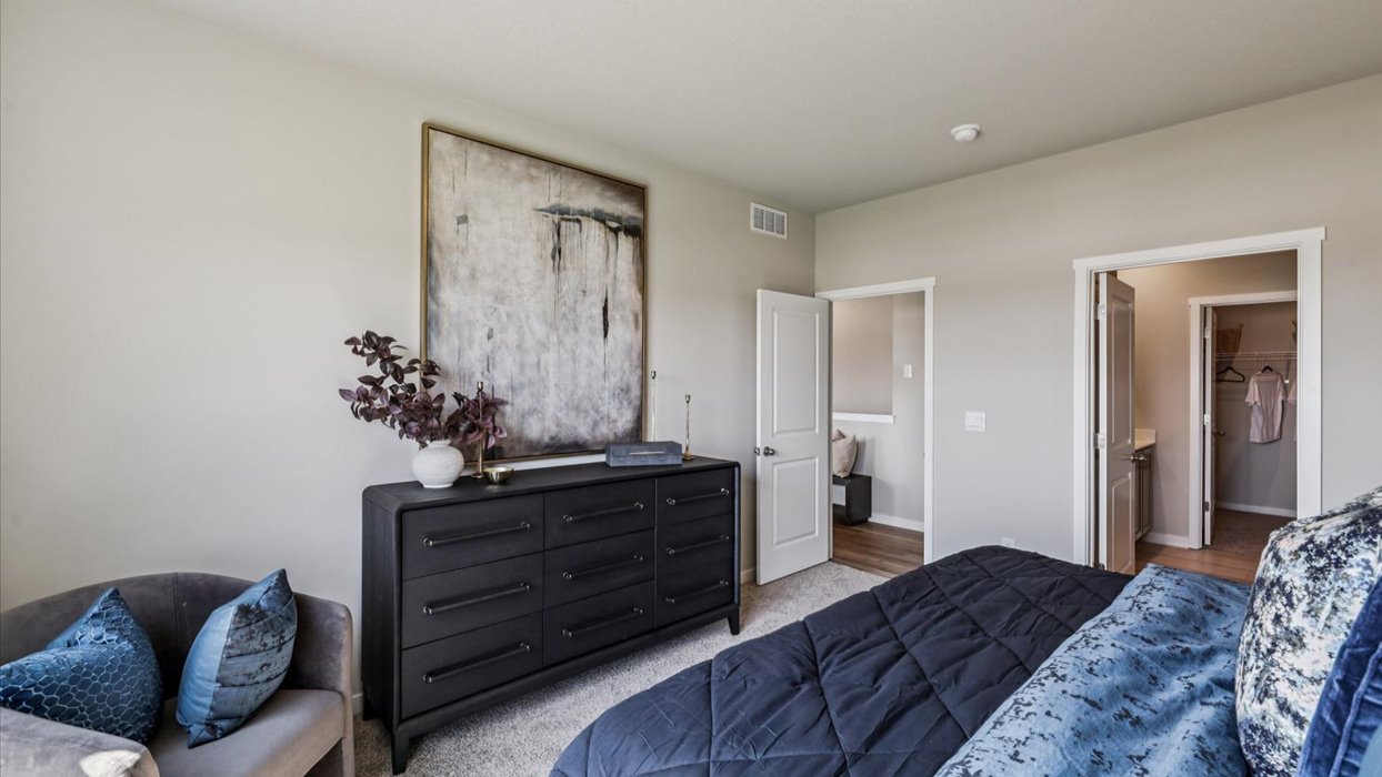 Spacious primary suite with natural light, attached bathroom, & walk in closet