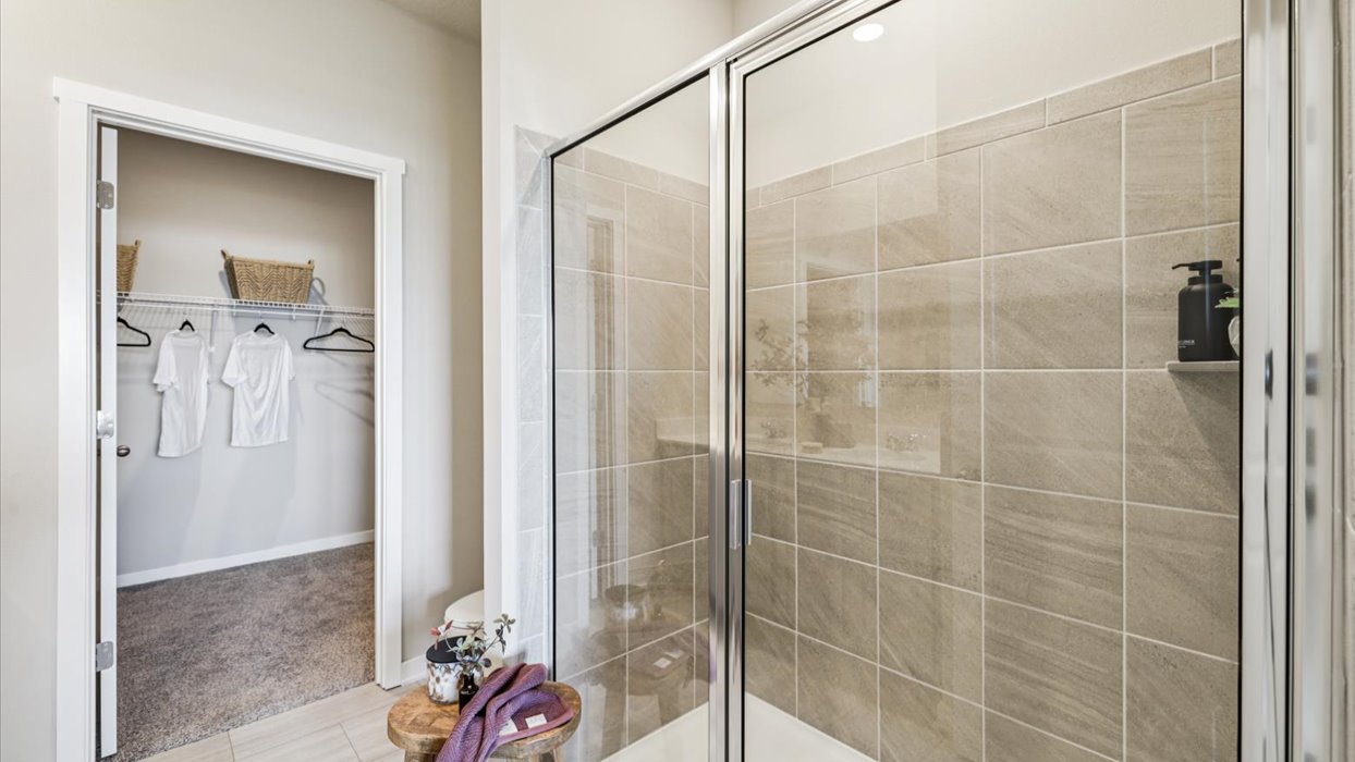 Spacious bathroom with white cabinetry and double sinks