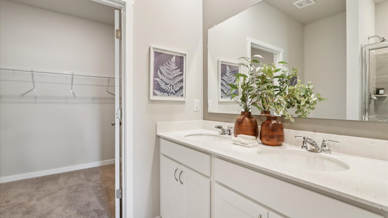 Spacious bathroom with white cabinetry and double sinks