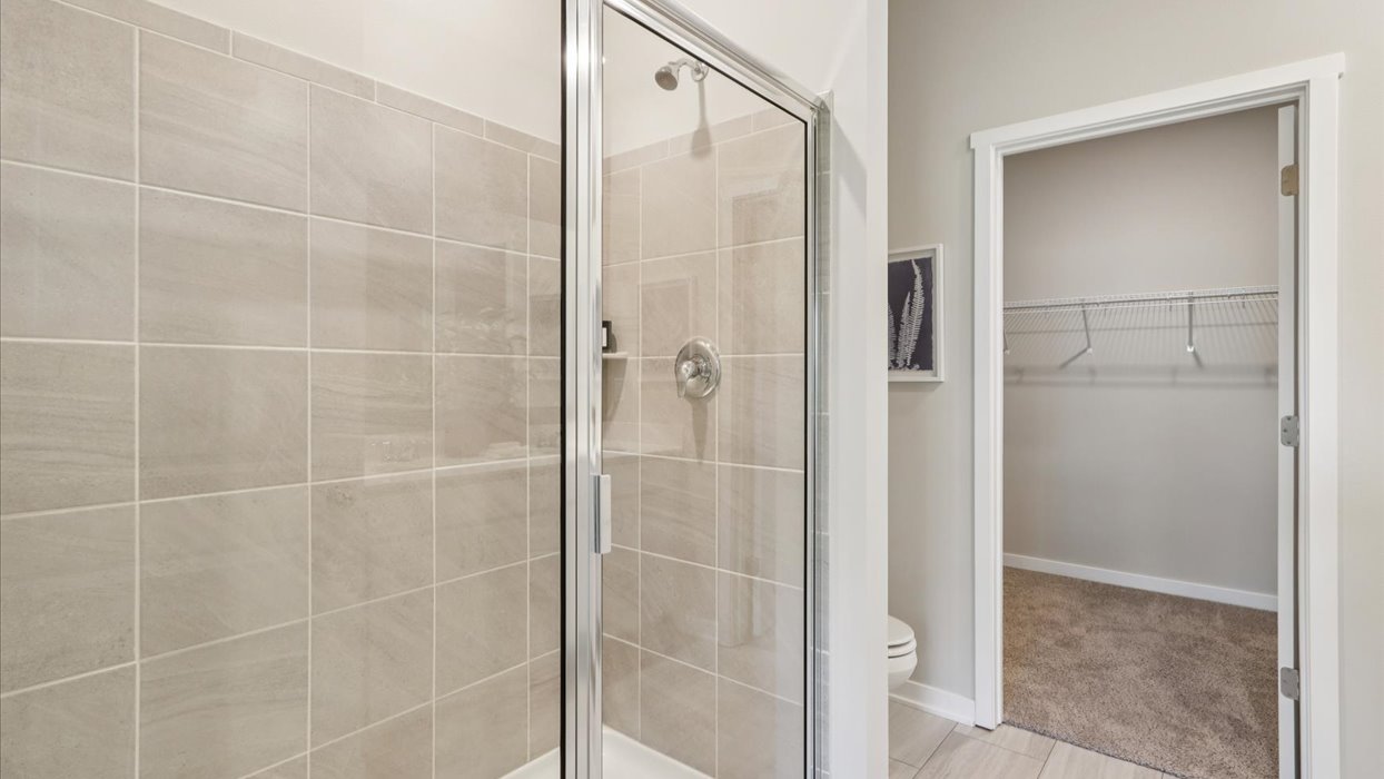 Spacious bathroom with white cabinetry and double sinks