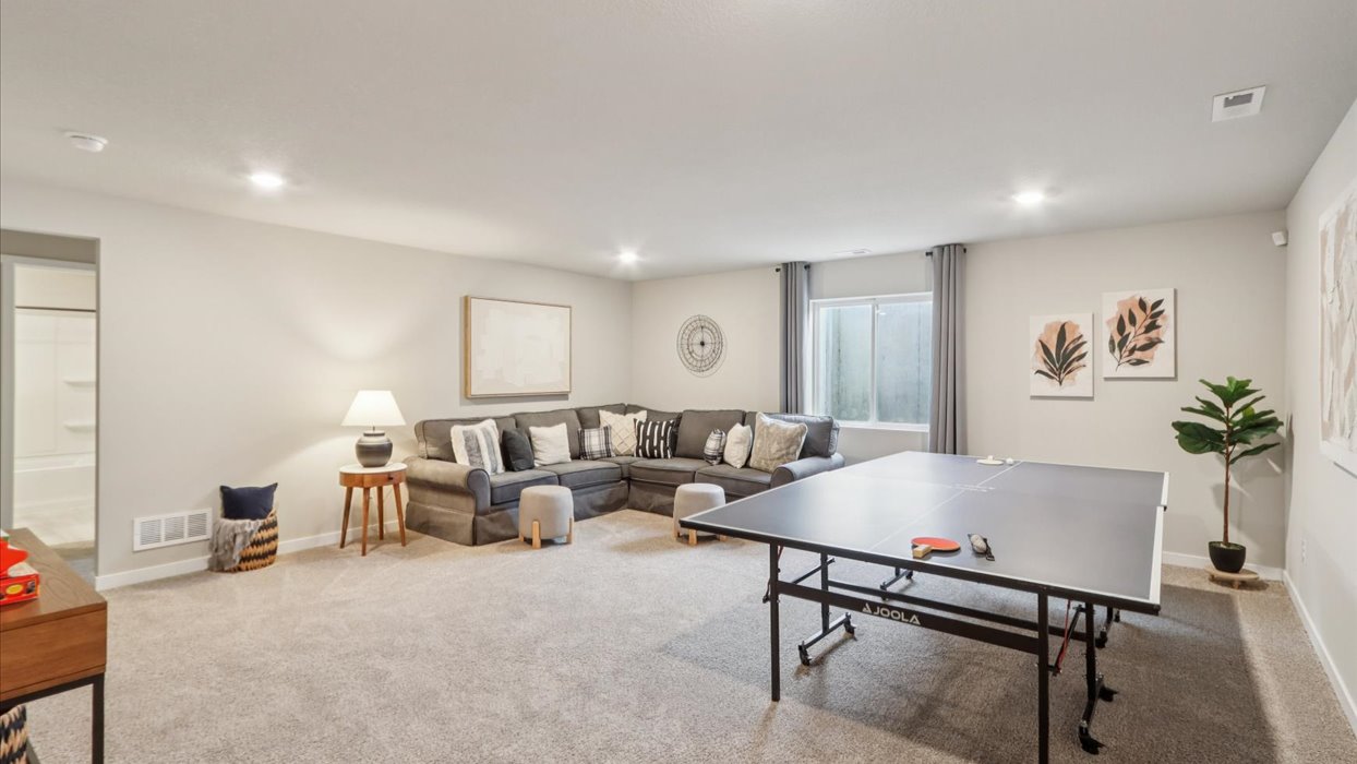 Finished basement living area with comfortable seating space and flexible room for entertaining or relaxing.