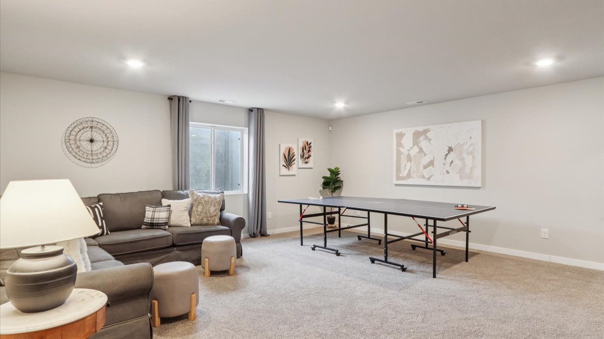 Finished basement living area with comfortable seating space and flexible room for entertaining or relaxing.