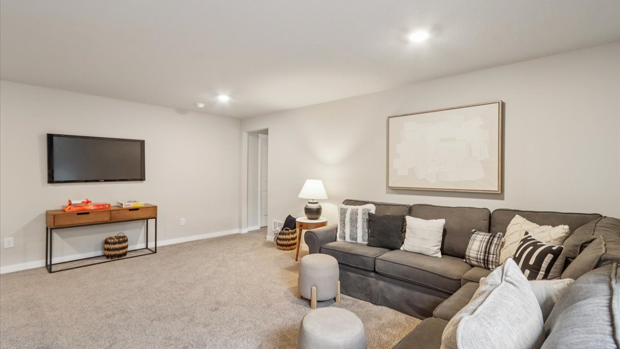 Finished basement living area with comfortable seating space and flexible room for entertaining or relaxing.
