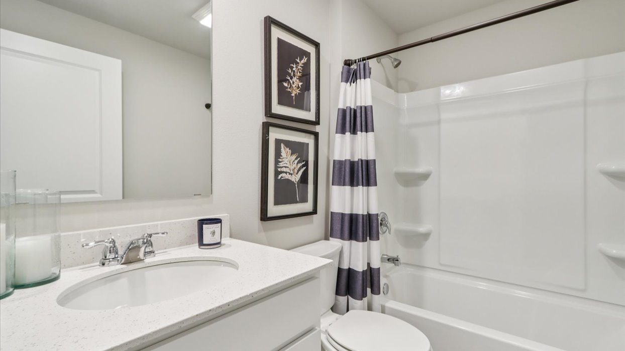 Stylish lower-level bathroom featuring contemporary fixtures and convenient access from the finished basement.