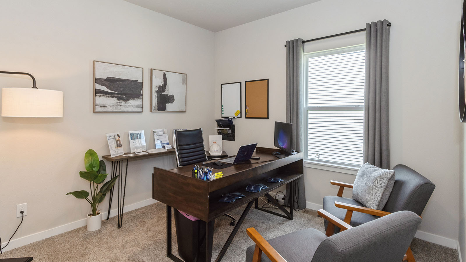 second bedroom with small window staged as a home office