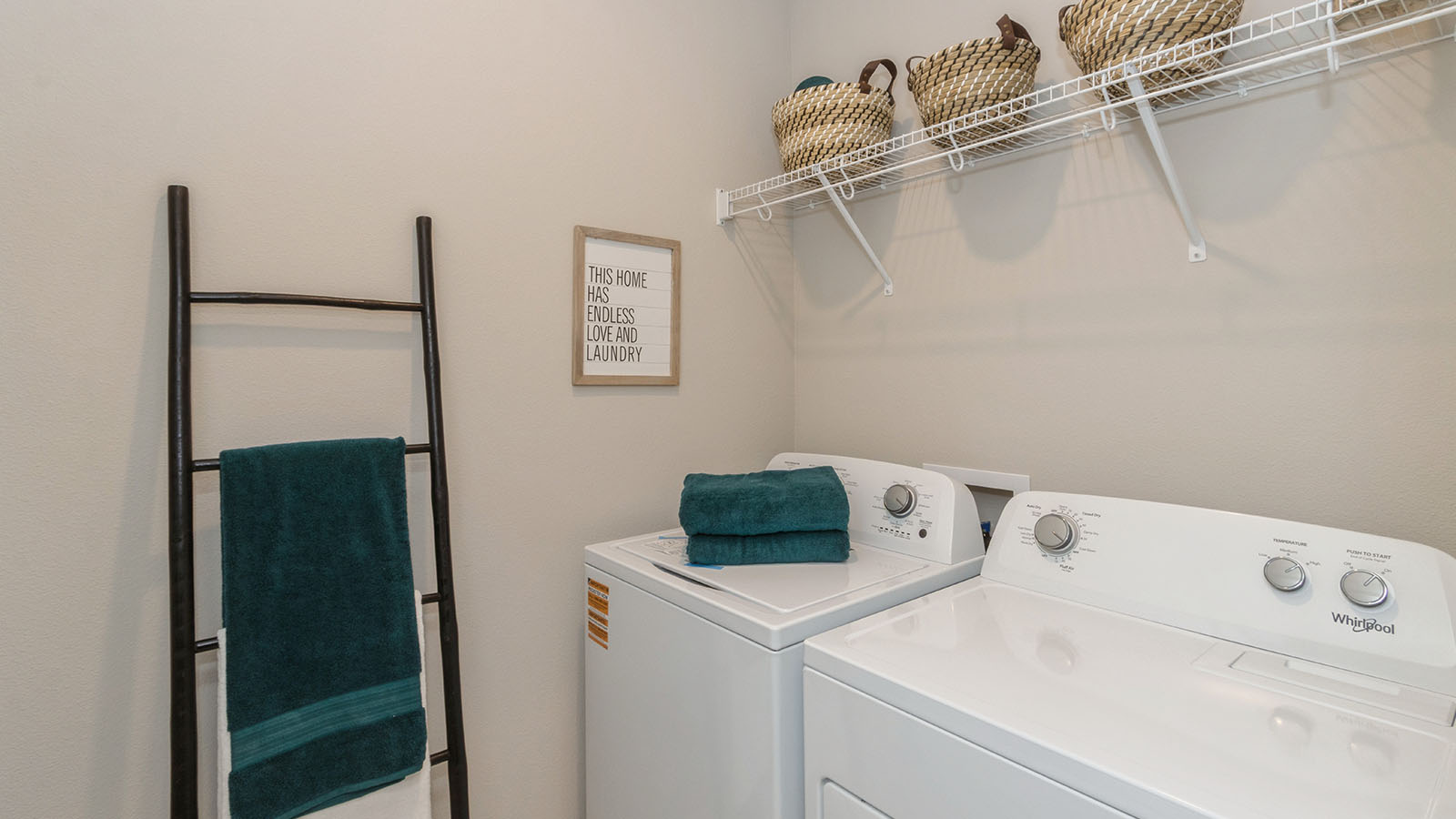laundry room with washer and dryer and white wire shelving