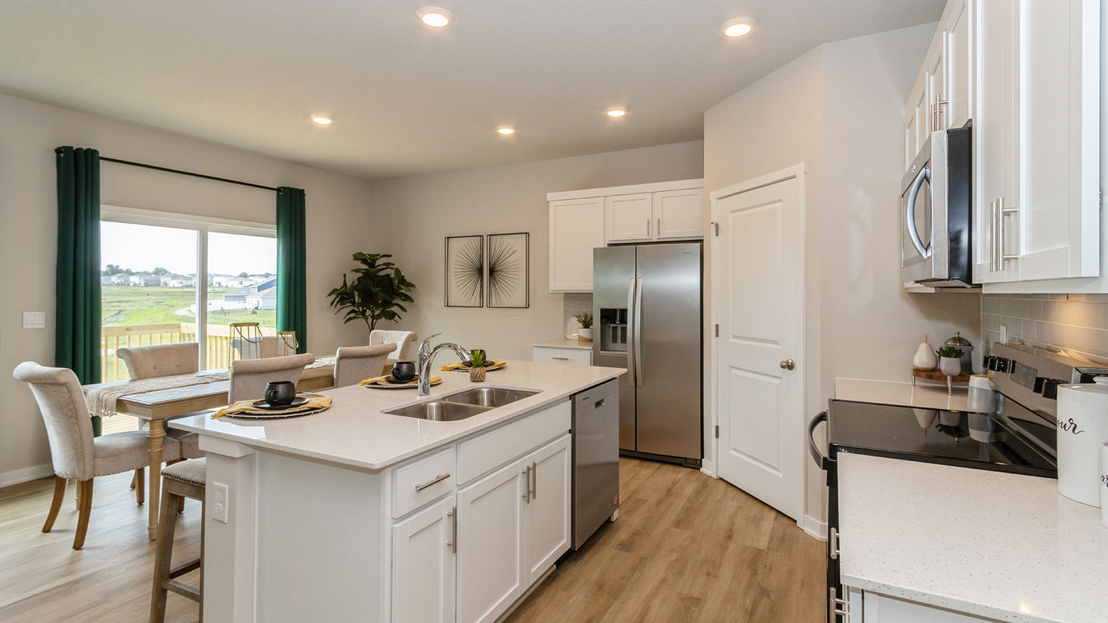 spacious kitchen with quartz countertops and white cabinets