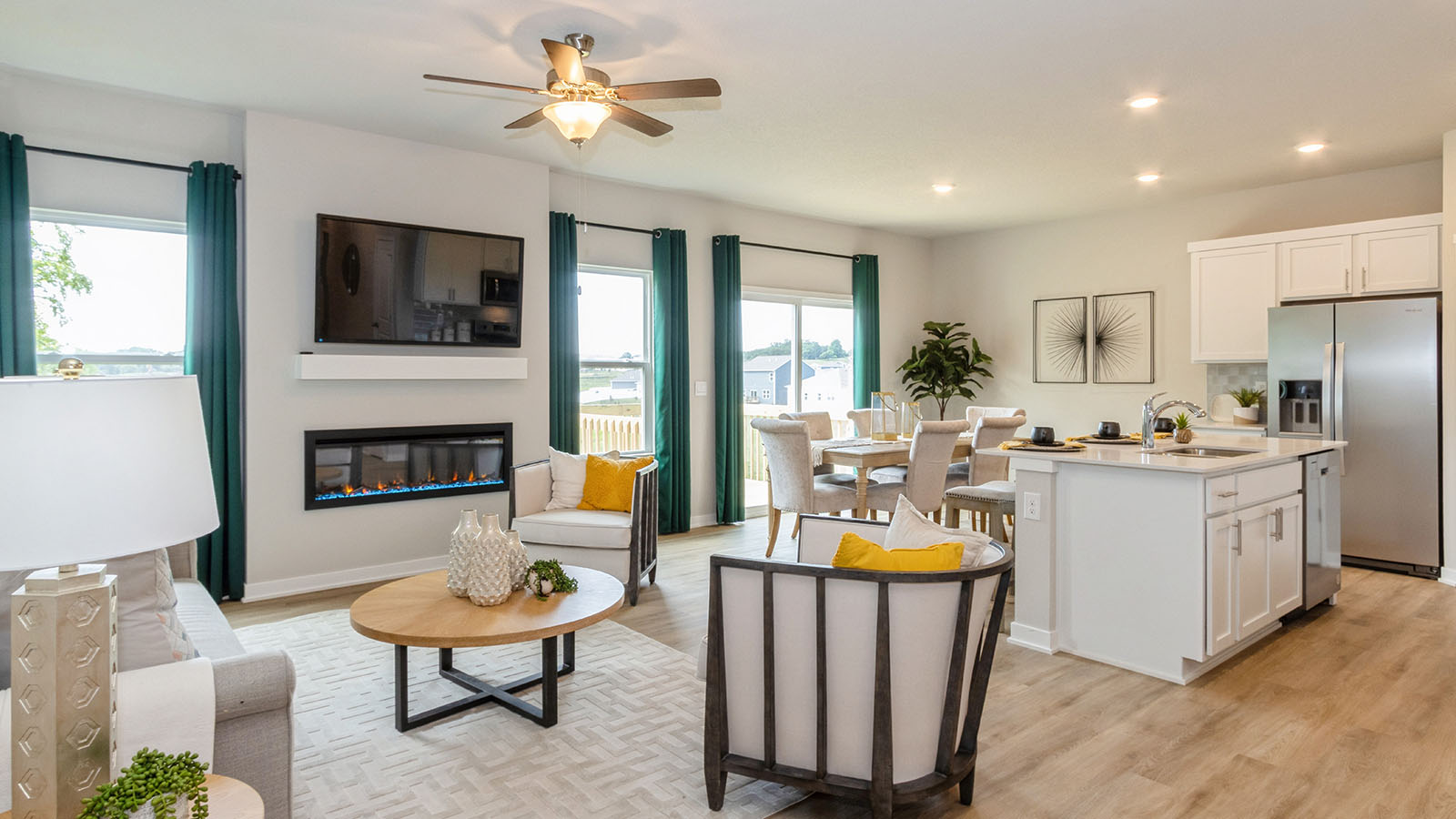spacious living room with electric fireplace and ceiling fan