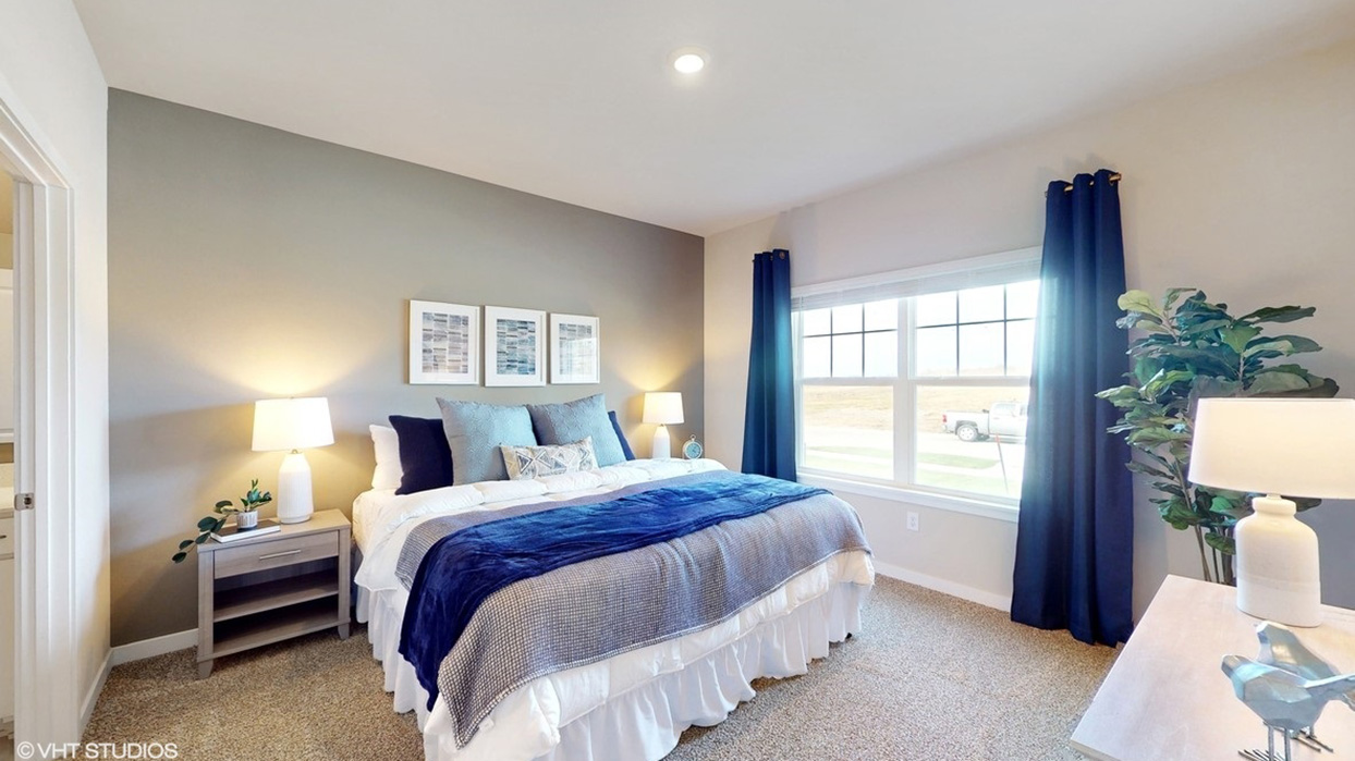 Primary bedroom of the Aldridge with a king bed, two nightstands and a dresser