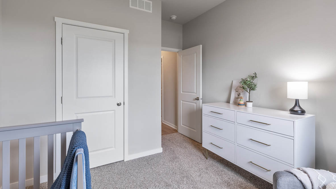Comfortable secondary bedroom with natural light, modern finishes, and versatile living space.