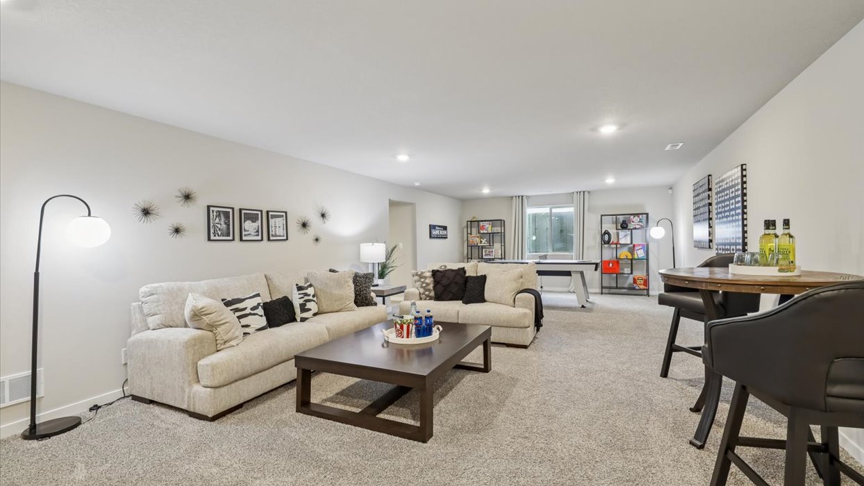 Finished basement living area with comfortable seating space and flexible room for entertaining or relaxing.Finished basement living area with comfortable seating space and flexible room for entertaining or relaxing.
