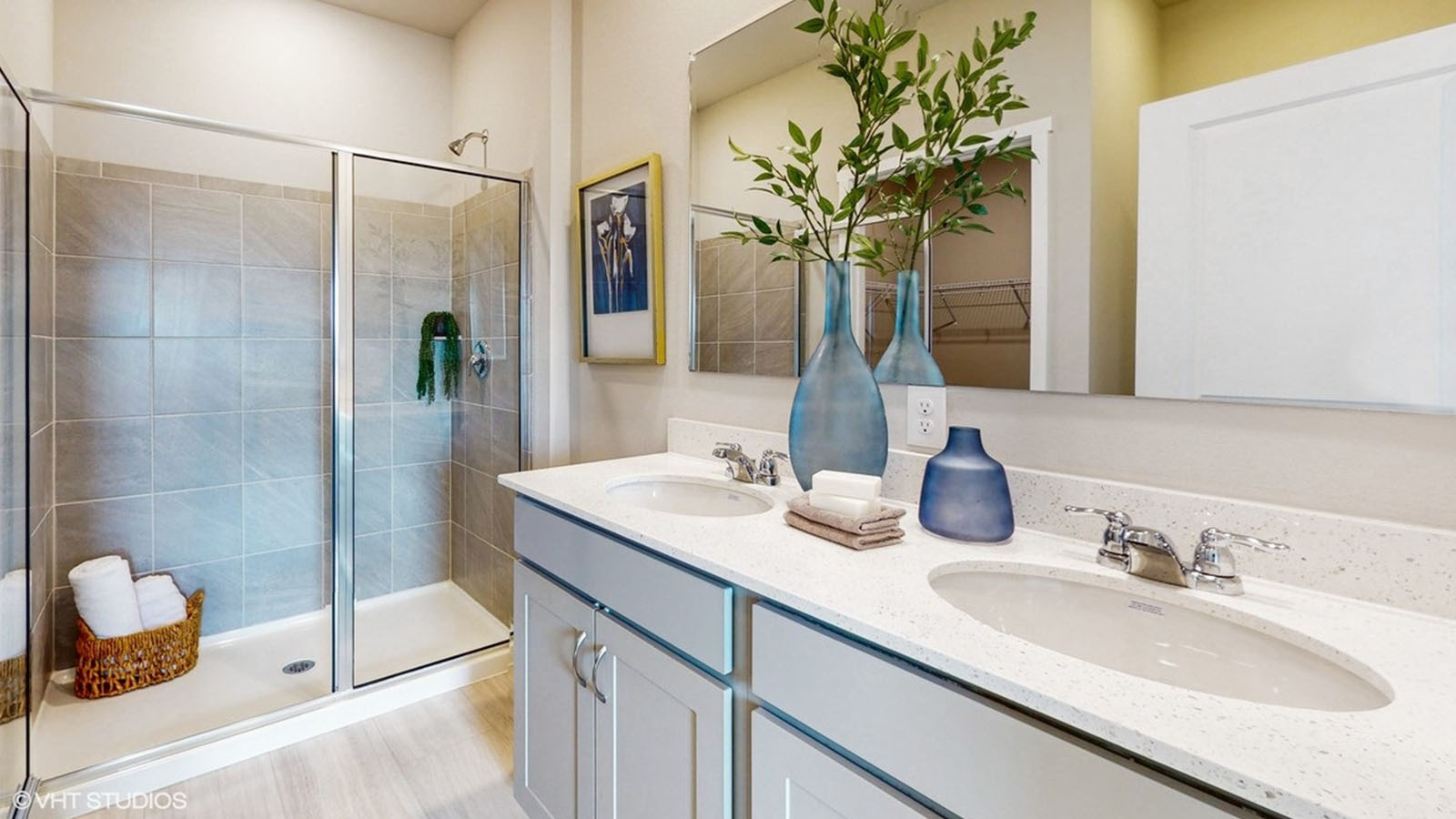 Primary bathroom with a glass shower door and dual sinks