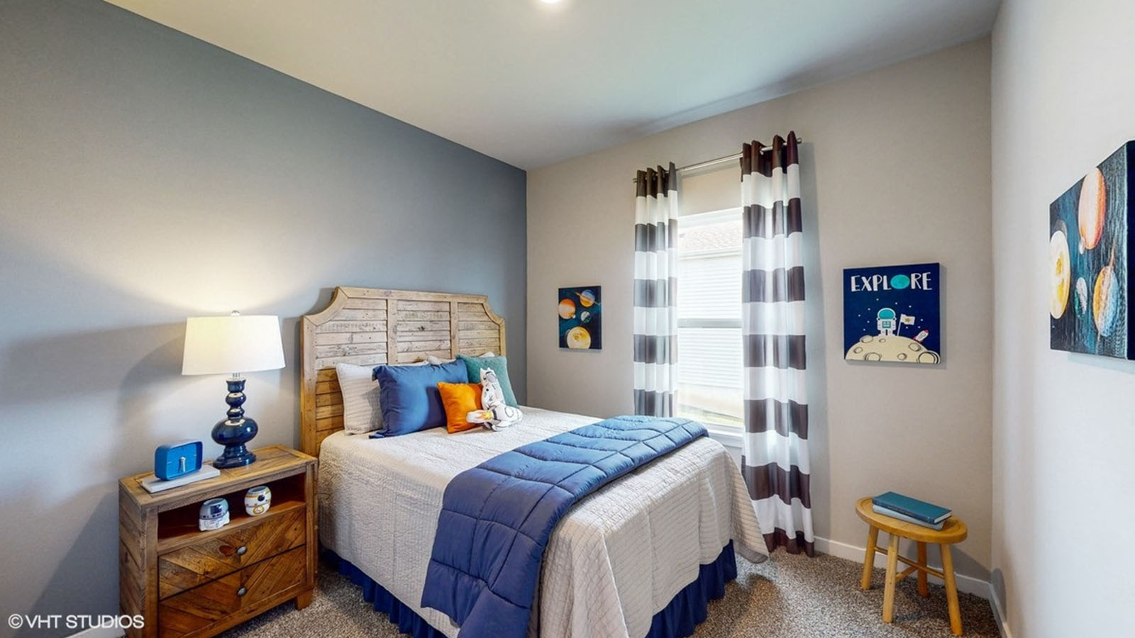 Third bedroom in the Roland with a queen bed, nightstands, and stool