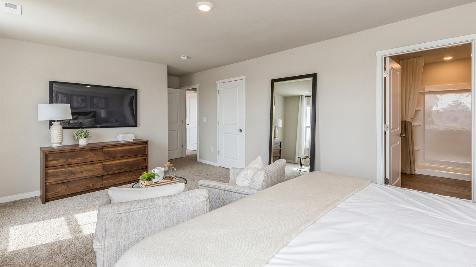 Primary bedroom with natural lighting and spacious layout