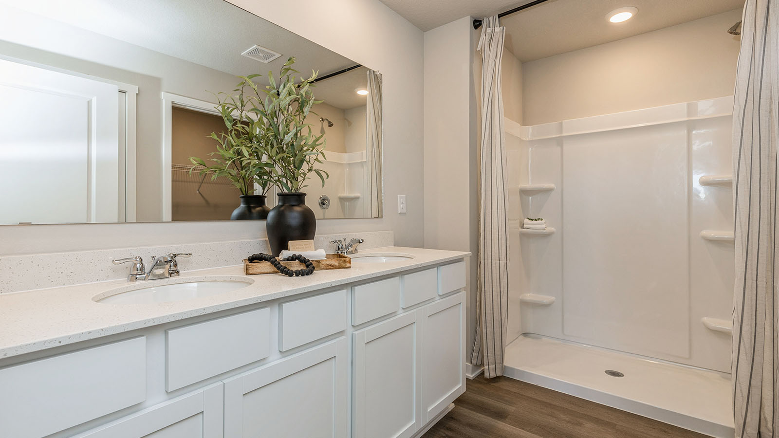 Primary bathroom with large mirror and dual sinks