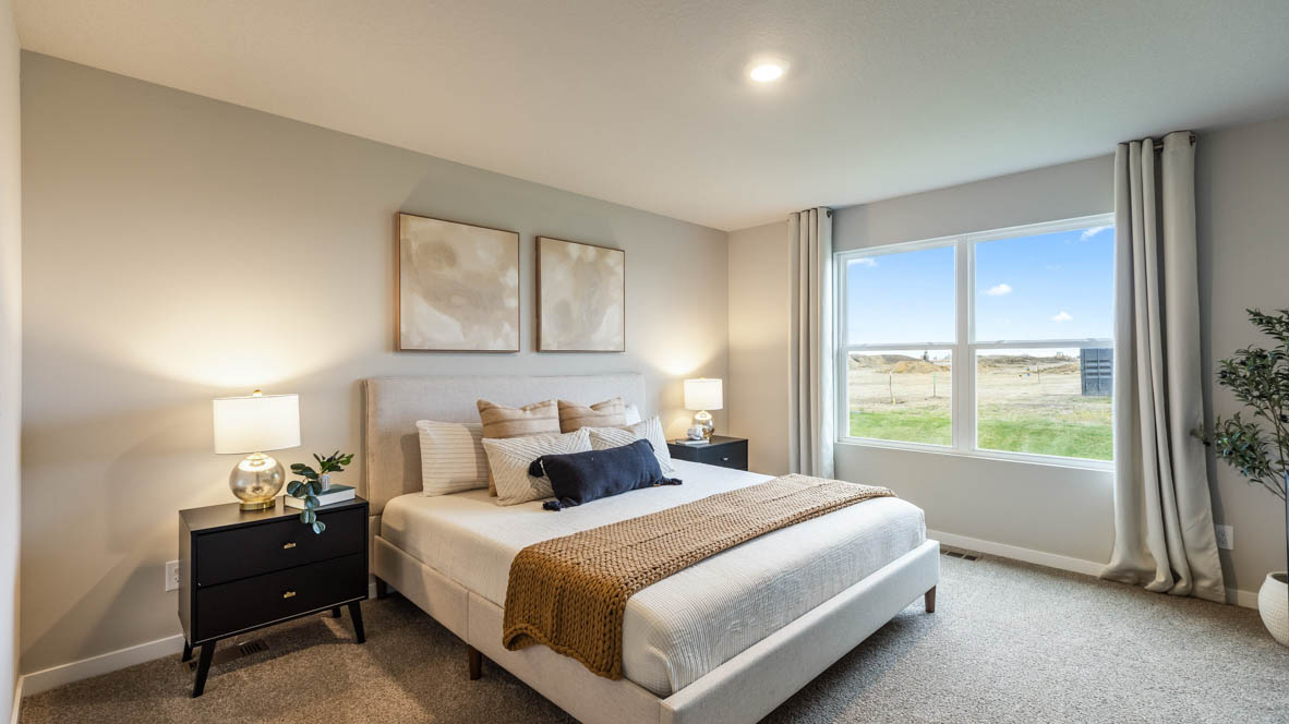 Spacious primary suite with natural light, attached bathroom, & walk in closet