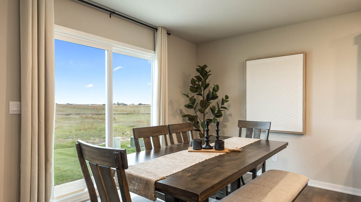 Open concept dining space with access to backyard