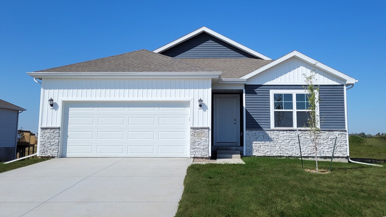 Front view of a newly constructed single-family home with attached garage.