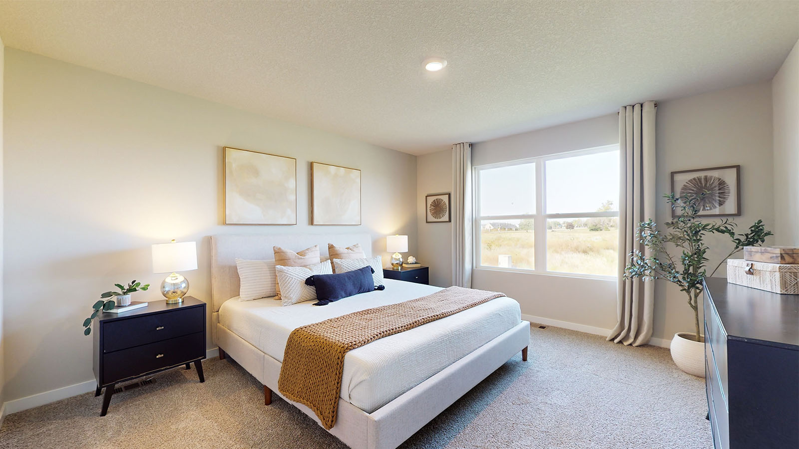 primary bedroom with large window and white bed
